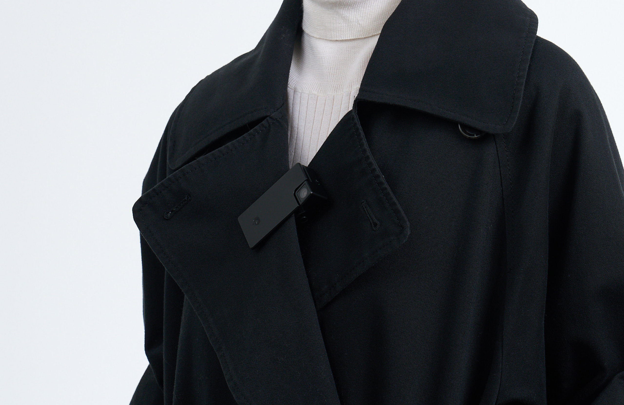 Person clipping Saveclip to a coat front