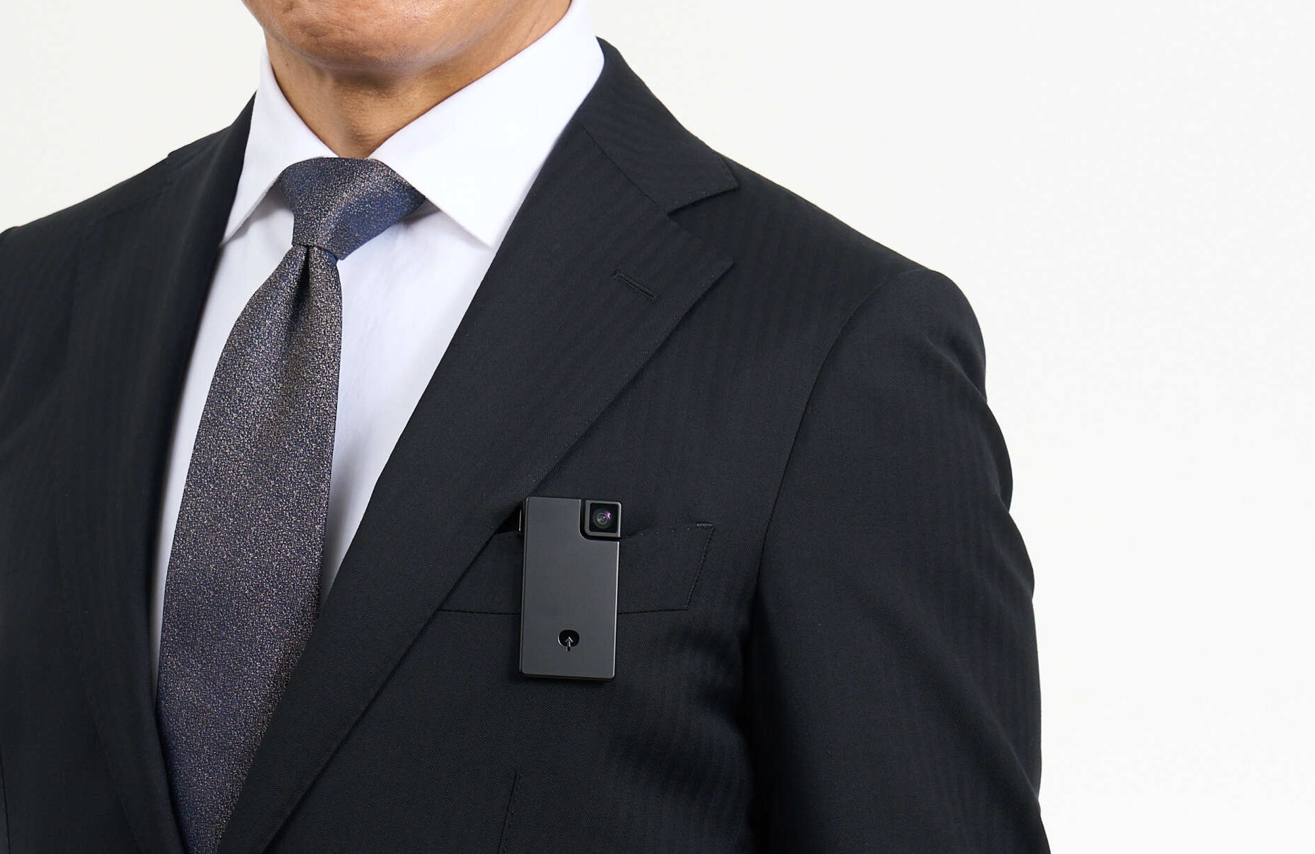 Person clipping Saveclip to a suit pocket