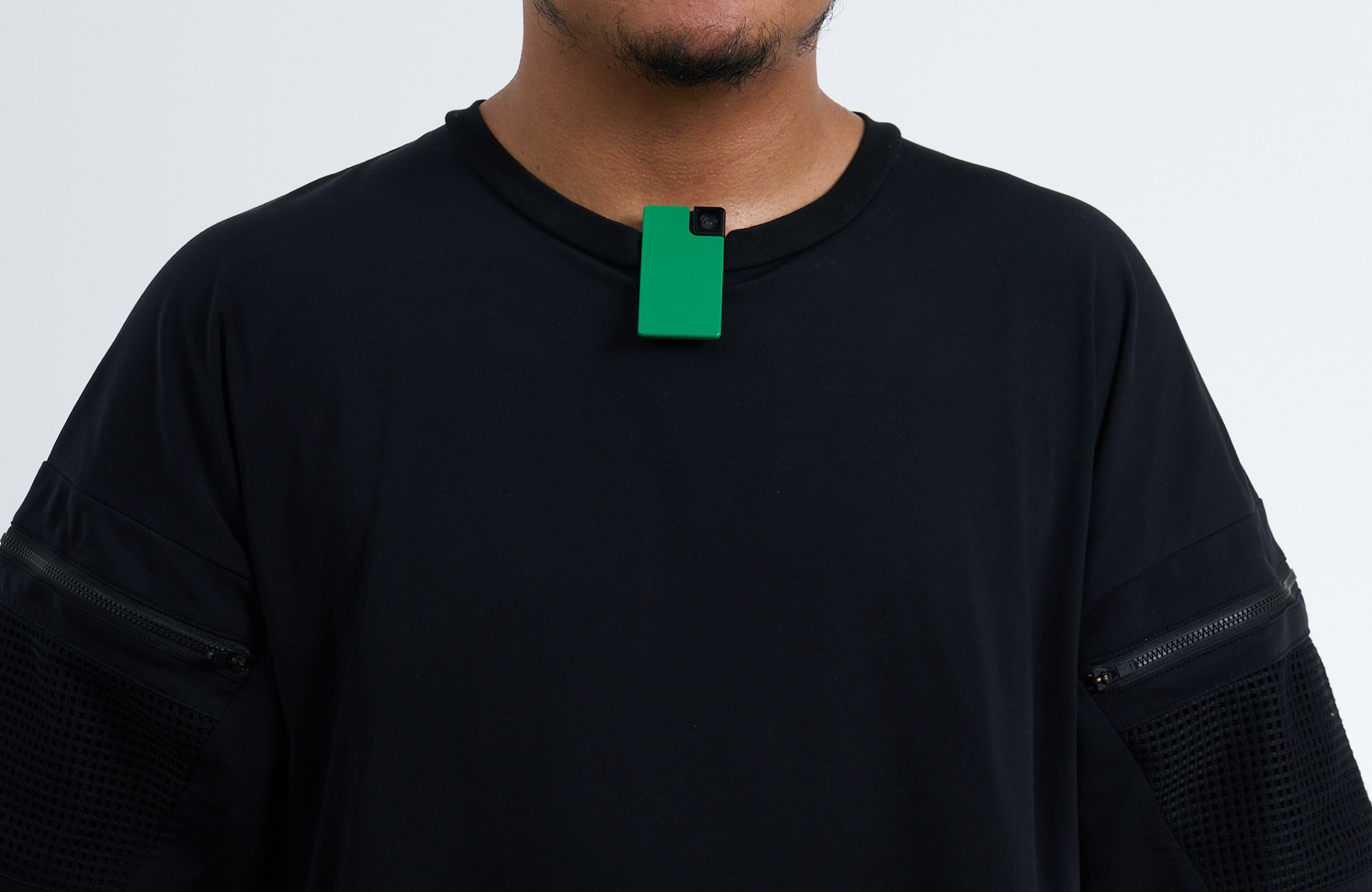Person clipping Saveclip to a T-shirt collar